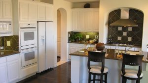 A kitchen with white cabinetry