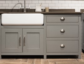 Close-up view of gray kitchen cabinets and drawers.