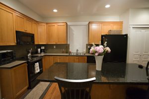 Kitchen area looks faboulus with refaced cabinets and dining 