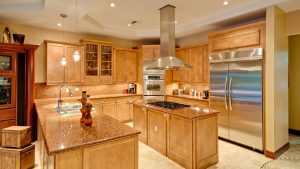 A luxury kitchen with wood cabinets and brown countertops.