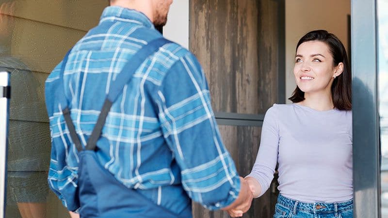 Woman shaking hands with mechanic