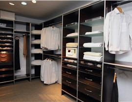 Organized bedroom closet with lighting