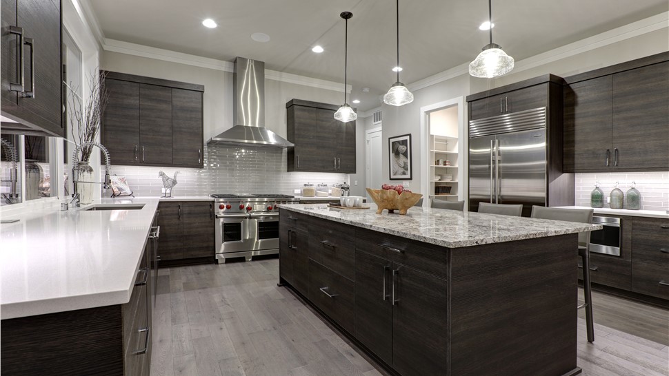 Sleek kitchen with dark gray cabinets and light countertops