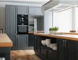 A beautiful kitchen with gray and black cabinets