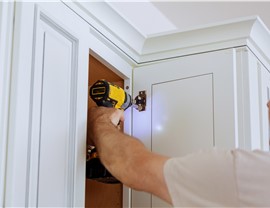 Technician installing cabinet door